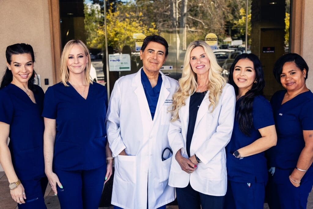 Four doctors standing in front of a building.